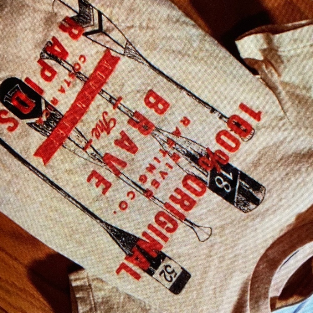 Features bold graphic sleeve blouse